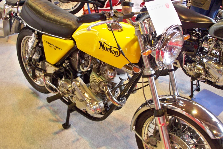 a yellow and black motorcycle on display in a room