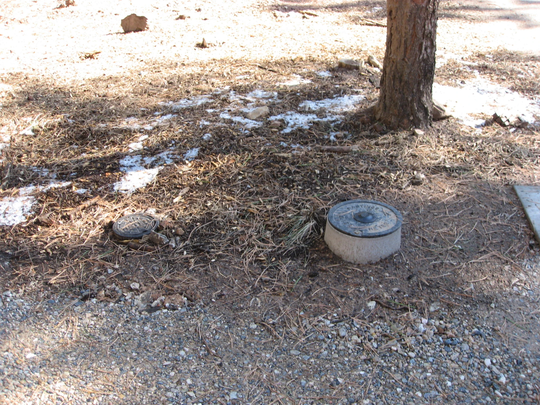 a dirty trash can is sitting in the dirt