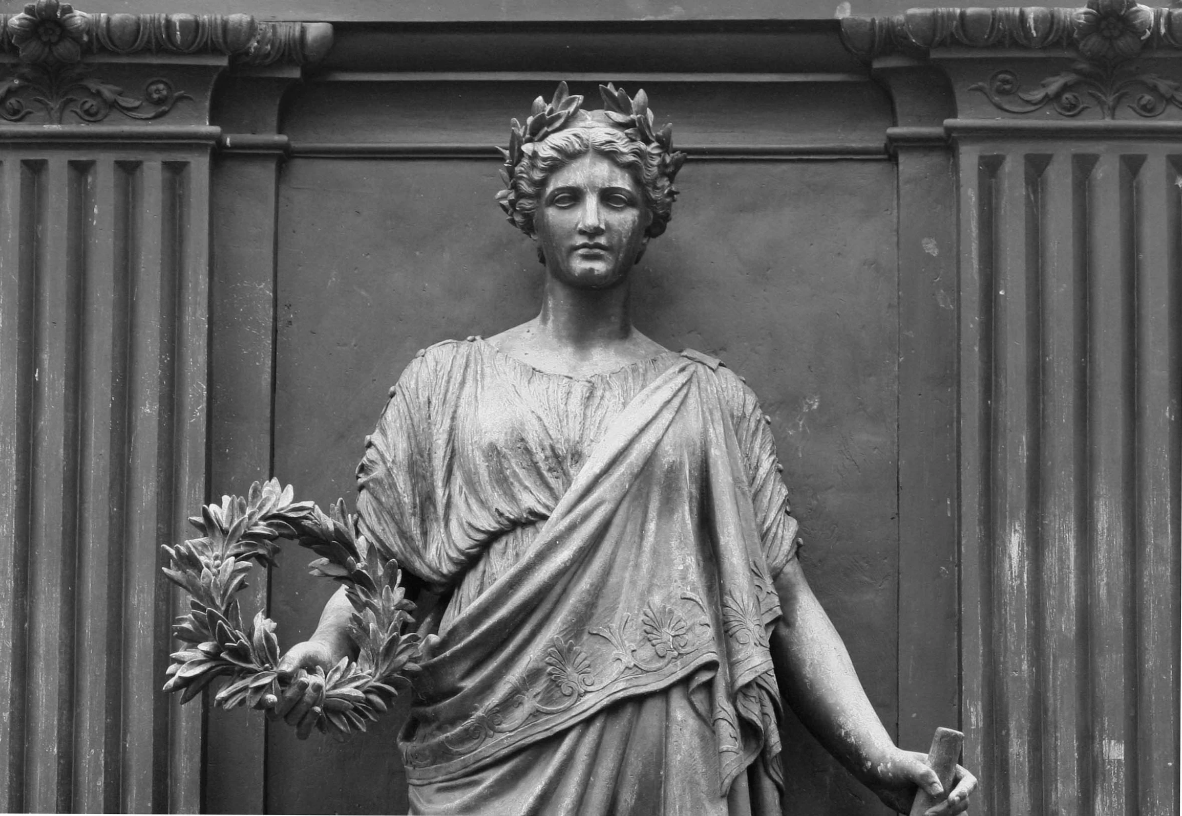 statue of roman statue holding a bouquet of flowers