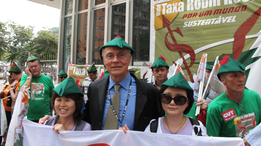 group of people carrying banners with two men holding a sign