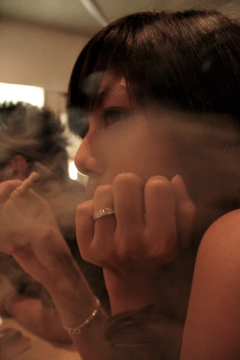 a woman smoking and holding a cigarette on her hand