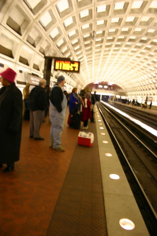 people are waiting for a train on a platform