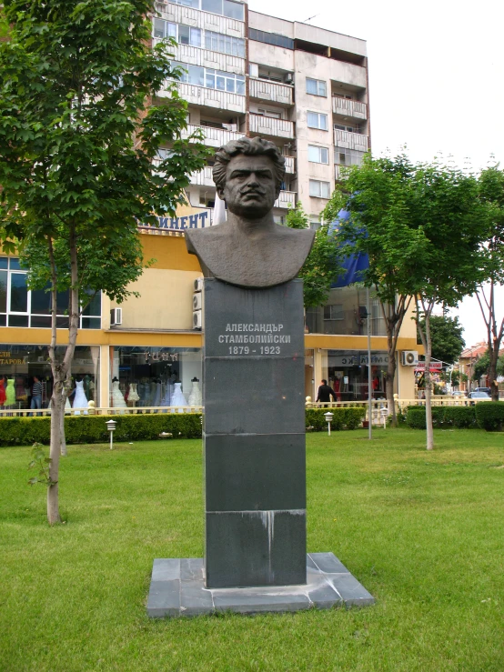 a statue of a person next to a large building