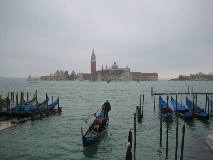 a boat is parked near a bunch of docks on a body of water