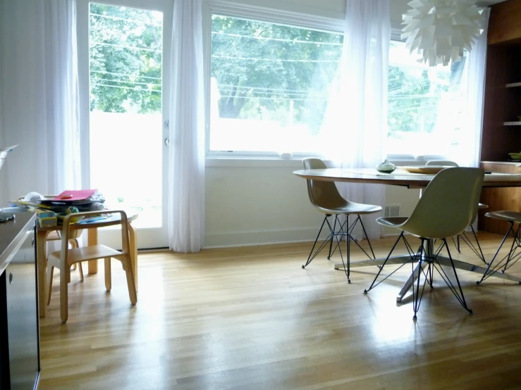 a room with a wood floor and a long table