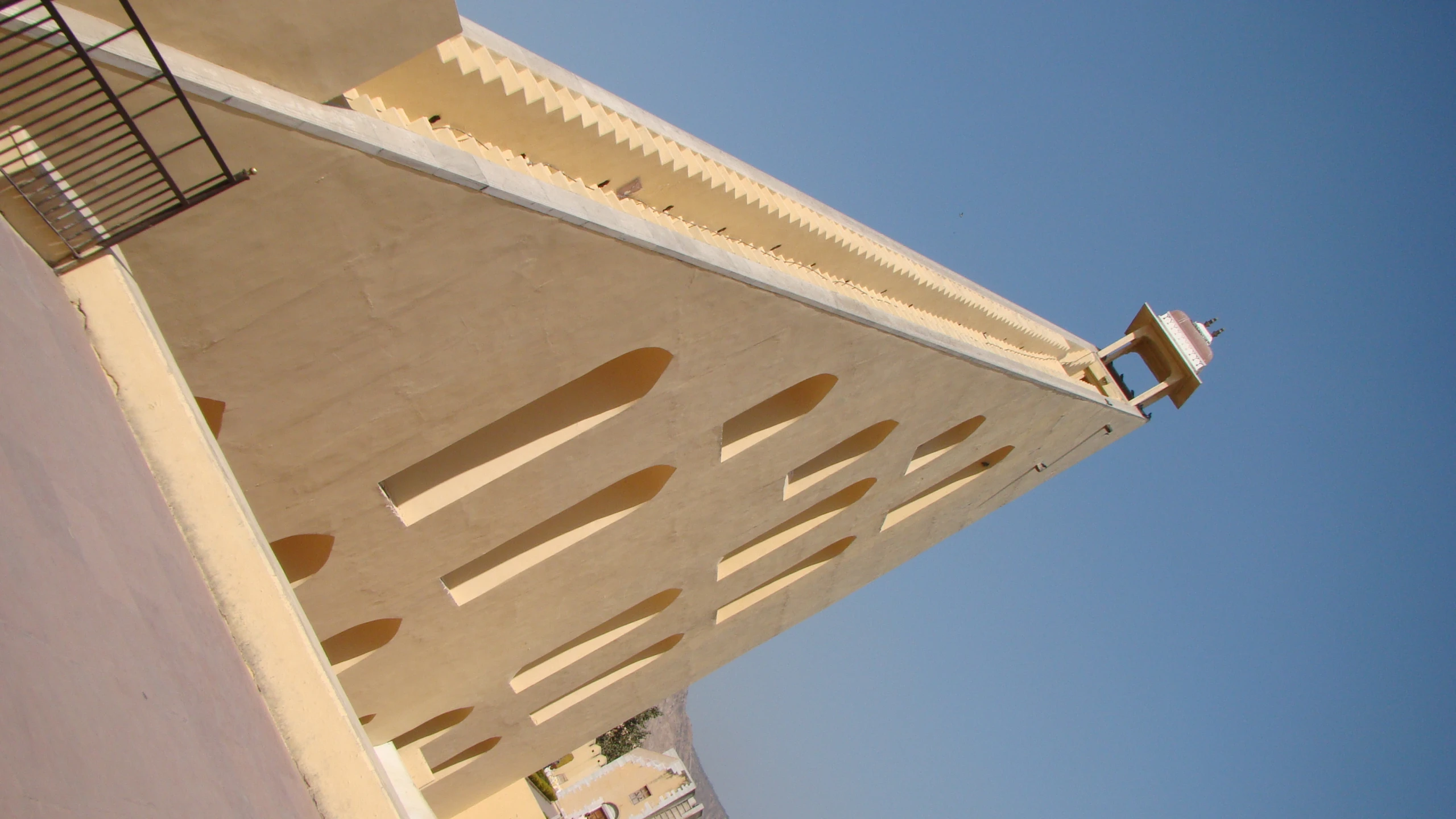 a tall concrete building with a clock tower on top