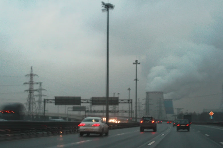 view of a freeway with smoke and fog coming out