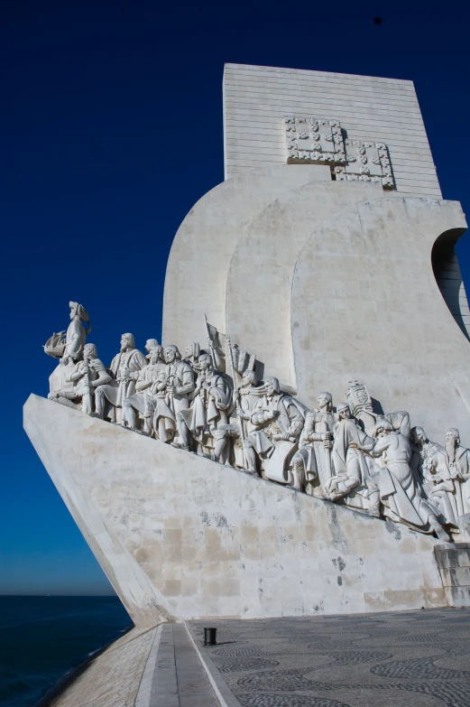 a close up of a memorial with statues around it