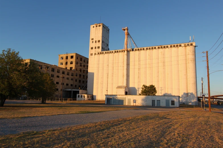 a view of a white building with two buildings and the sky