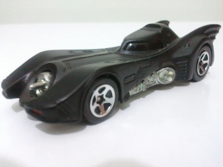 a plastic batmobile model sitting on top of a white table