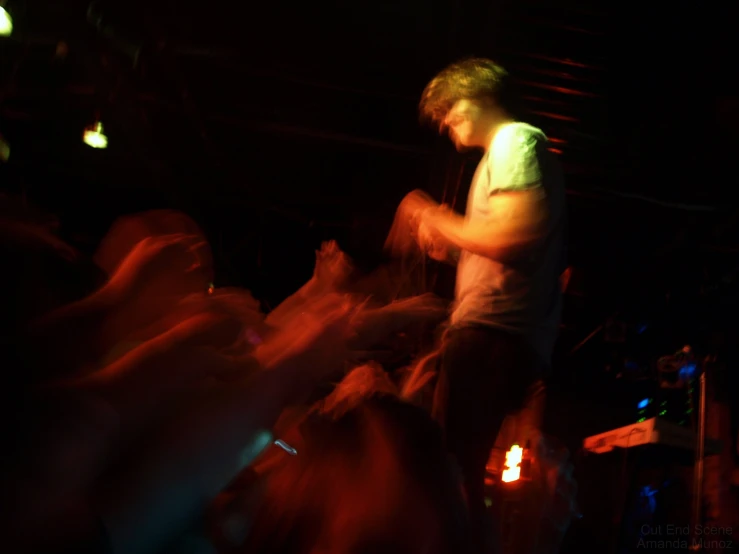 a male in a white shirt is standing on a stage