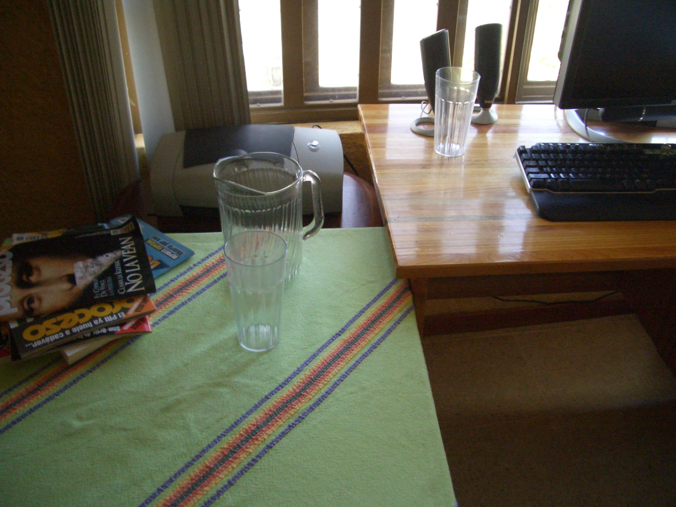 two glasses with water and book sitting on a table