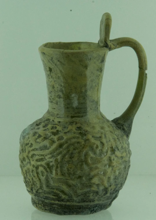 a large green vase with a handle and no handles