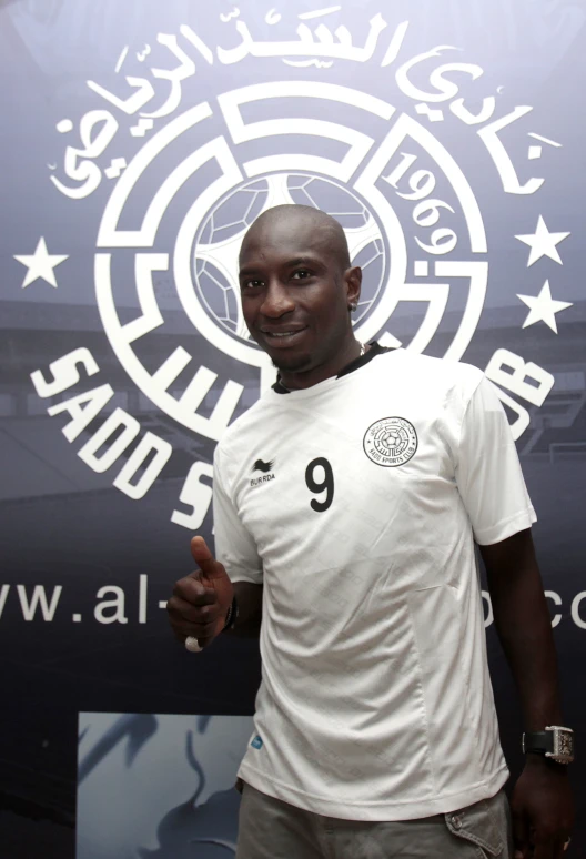 a man is standing next to a soccer ball in his hands