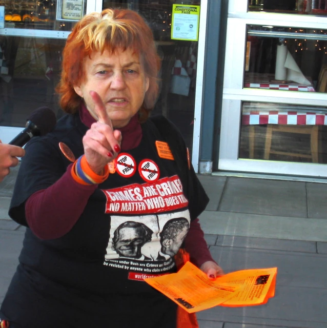 a woman with red hair is giving the peace sign