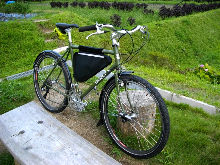 there is a bicycle that is sitting by a bench