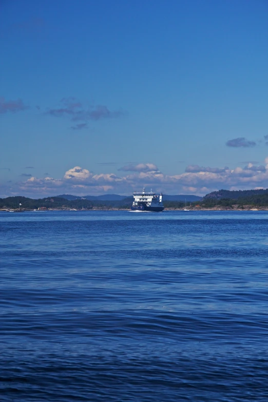 a white boat sailing down a large body of water