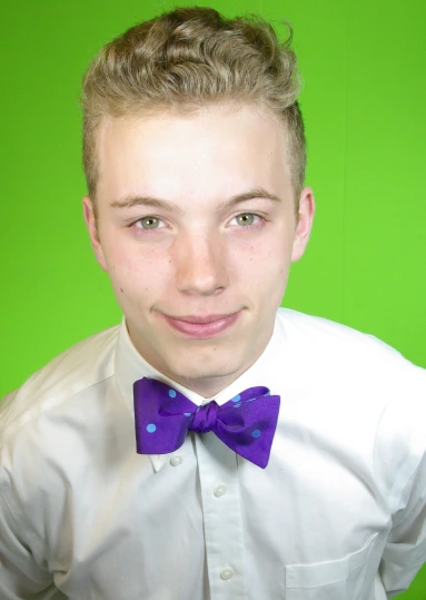 a close up of a young person wearing a bow tie