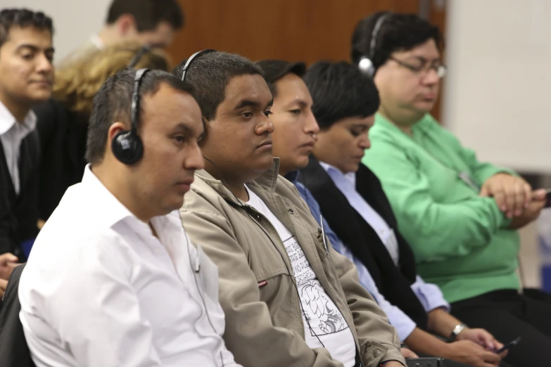 people in an audience wearing headphones