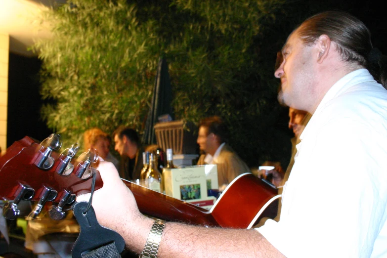 a man playing a guitar at an outdoor event