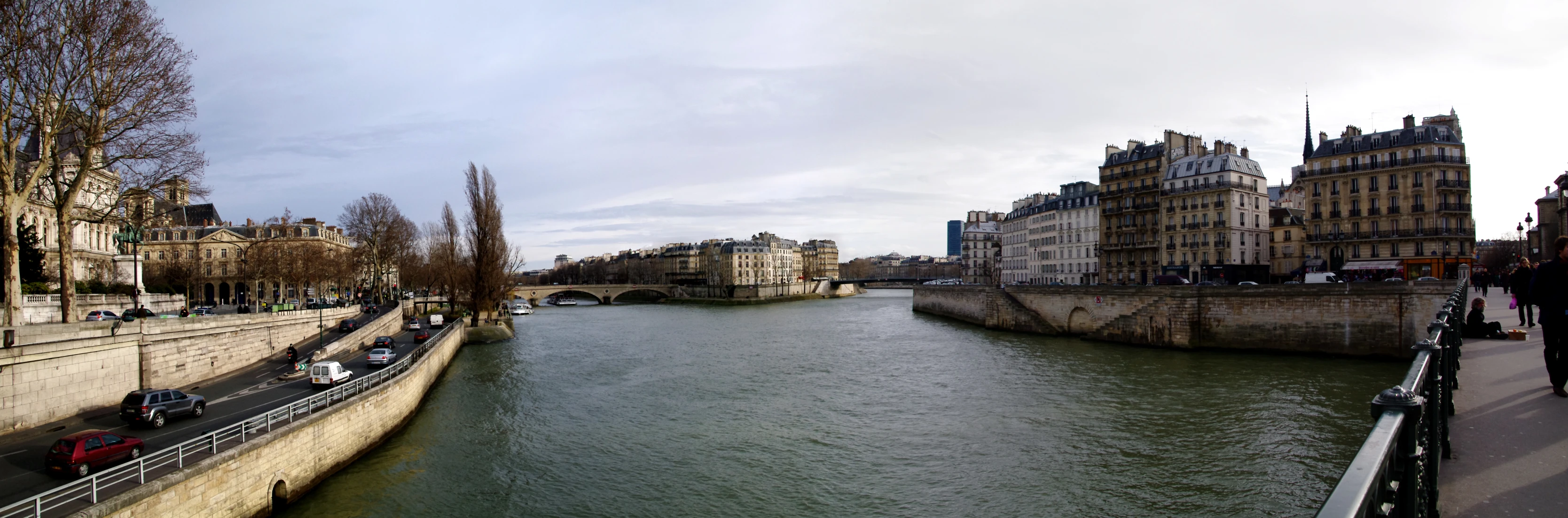 a river next to a very large building with tall towers