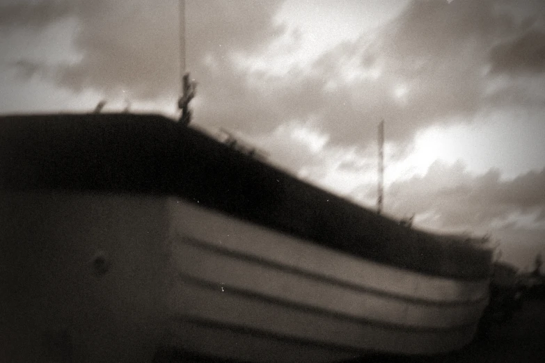 a boat in the ocean under cloudy skies