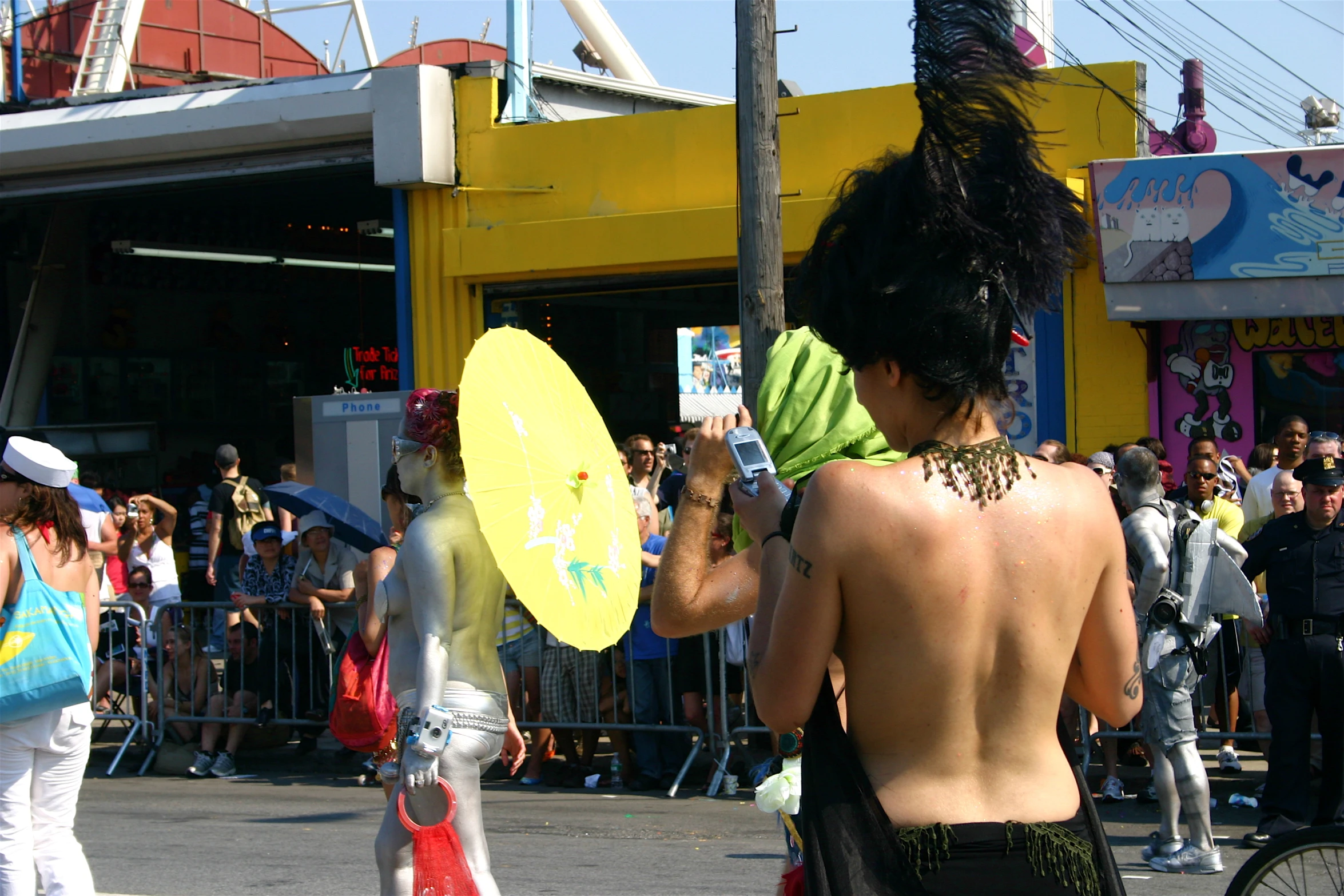 a man holding a yellow frisbee walking next to a woman