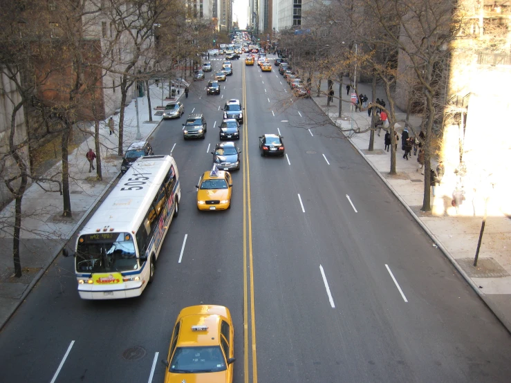 a street with cars and buses is shown from above