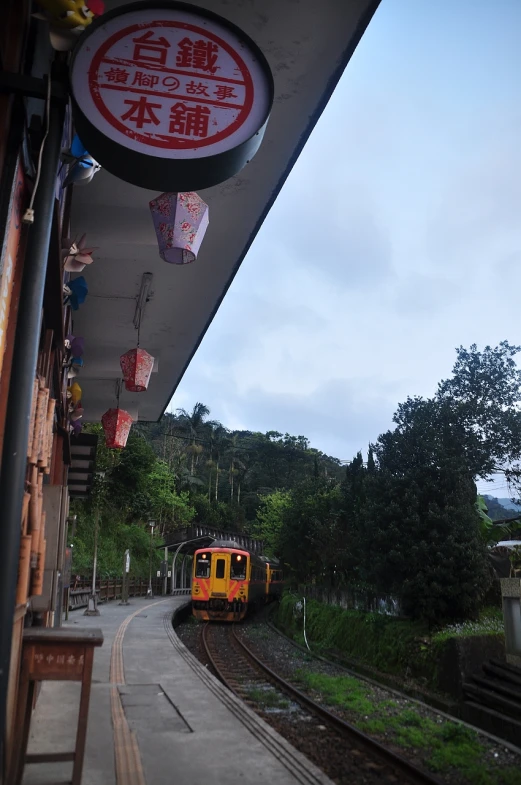 a small train pulling up to the train station