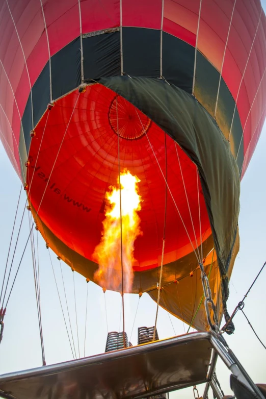 a bright red  air balloon with yellow fire