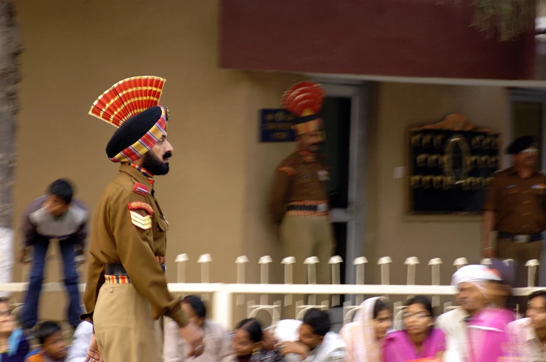 a man in uniform standing on a sidewalk