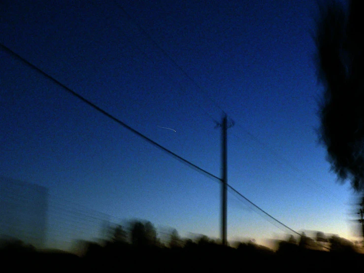 an image of a full moon at night from the road