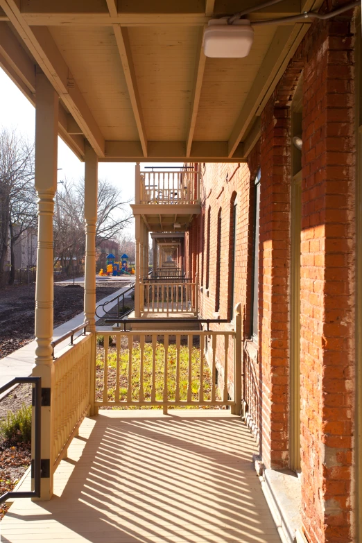 a balcony with railing, a building with balcony and an open area