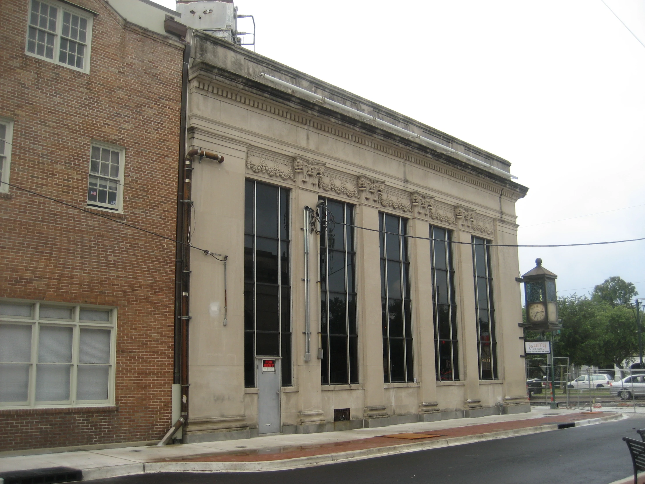 a building sits next to some street signs on the corner