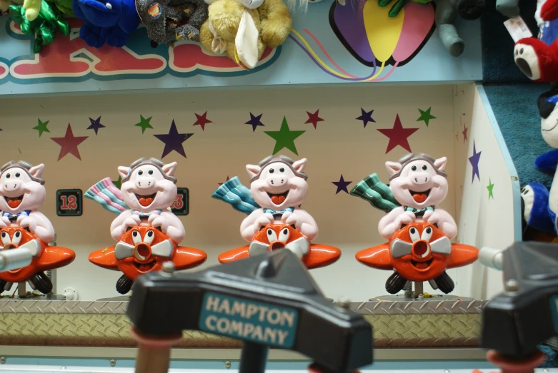 several toy pigs with different costumes are holding oranges