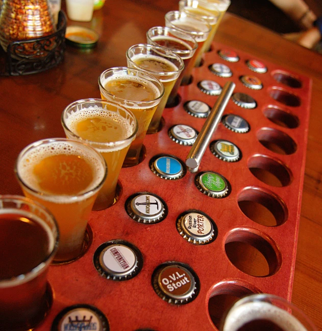 a wooden table with a bunch of beer samples