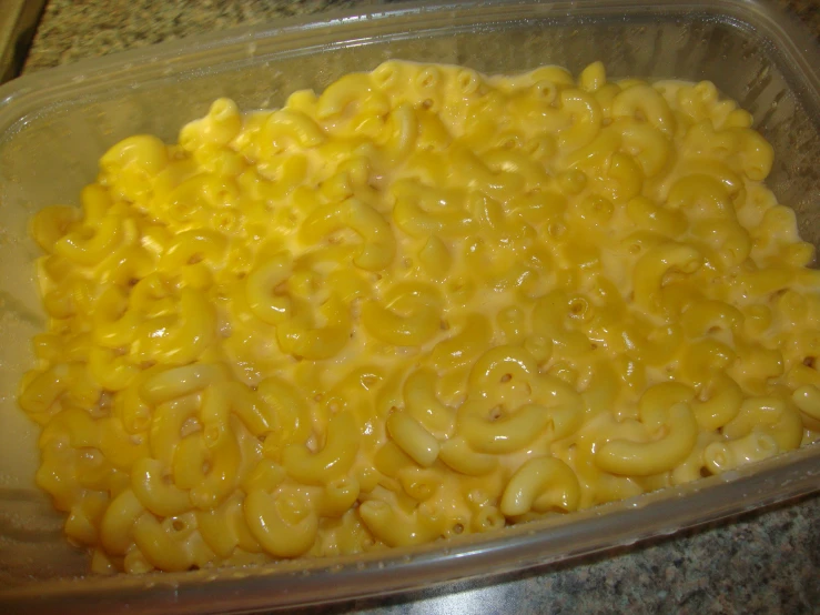 a container with macaroni and cheese in it
