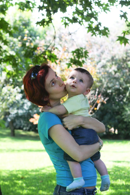 a woman is holding her son in her arms