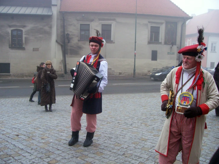 people are walking on a cobblestone road