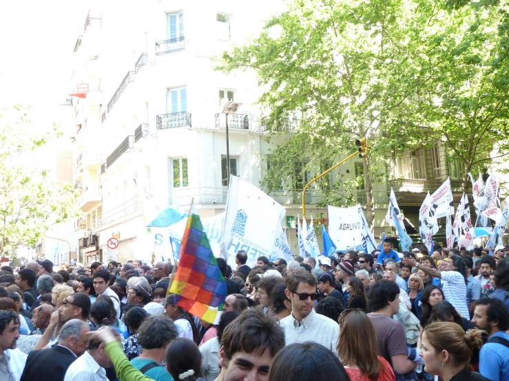 a crowd of people marching down a street