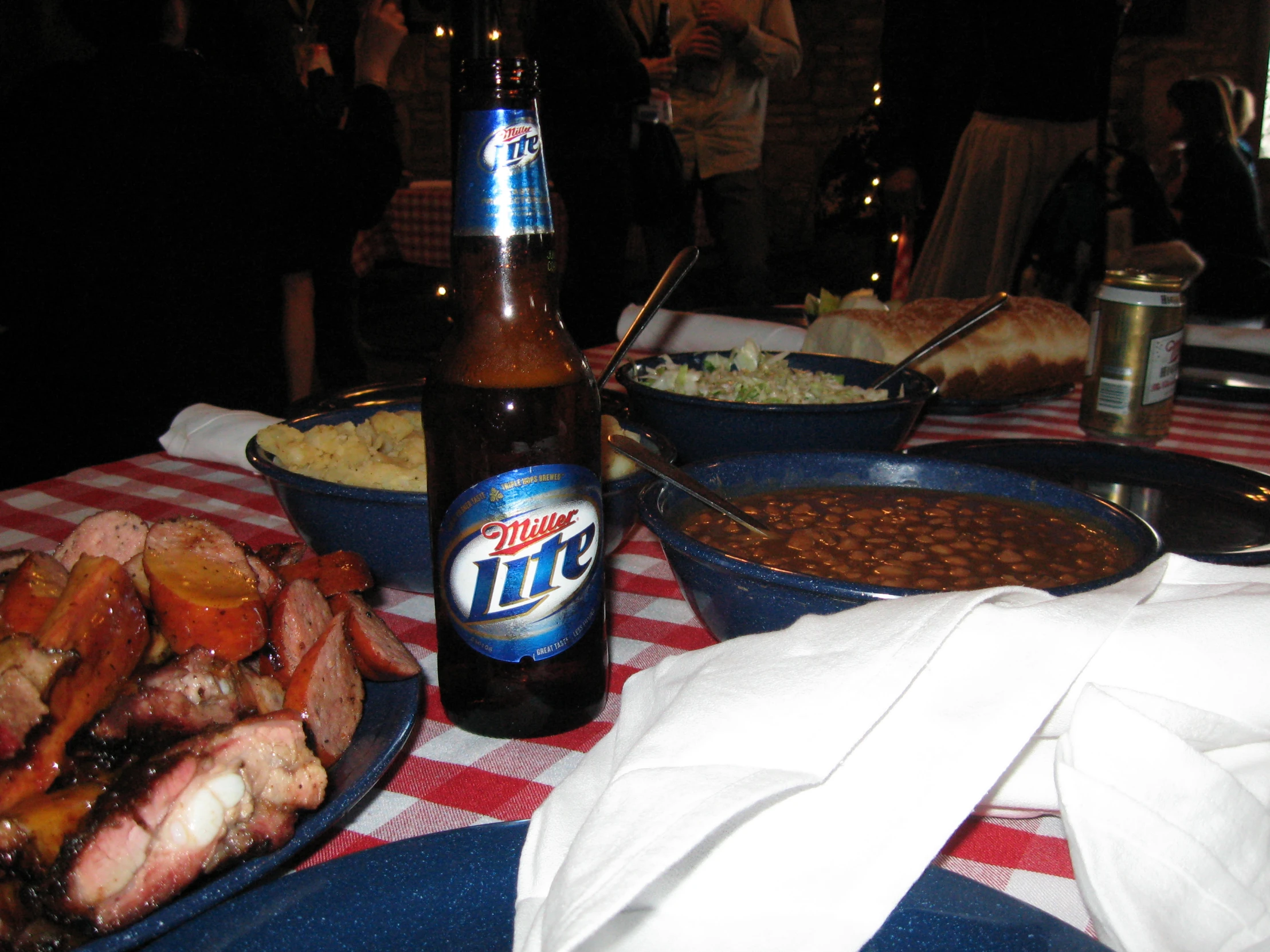 a bottle of beer is next to various foods