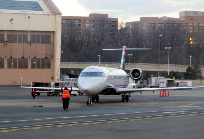 an airport with an airplane parked and luggage being loaded