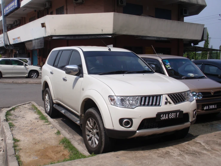 several cars parked near one another on the curb