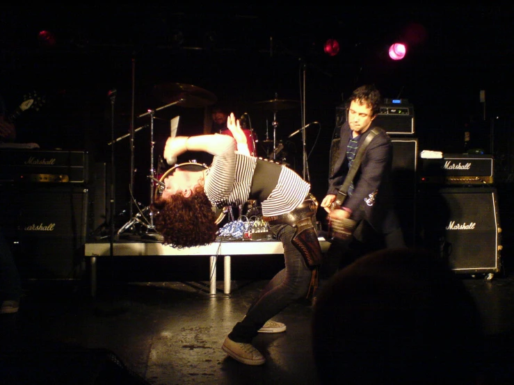 two male artists on stage performing tricks and some of them jumping