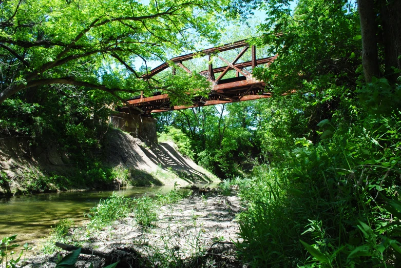 bridge spanning the width of a stream that's flowing under it