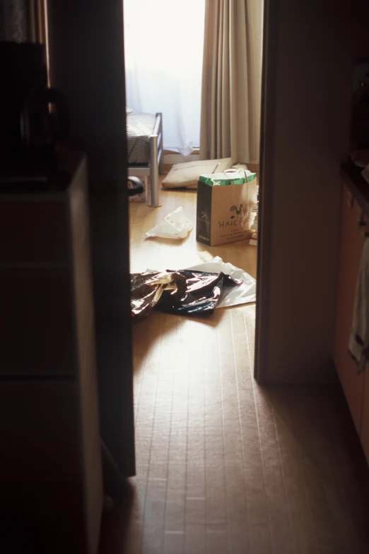 the door way into a room with boxes and paper on the floor