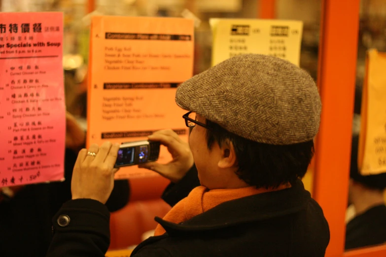 a man holding up a smart phone to take a po