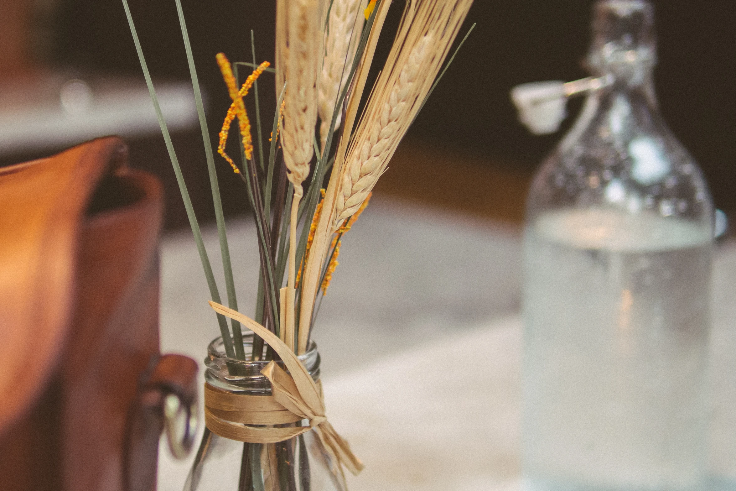 two flowers that are in a vase on a table