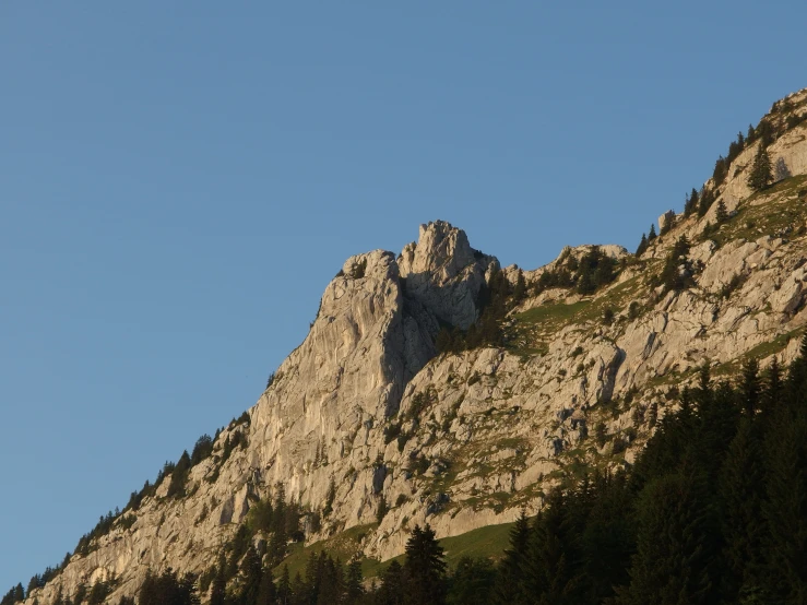 the silhouette of mountains against a blue sky