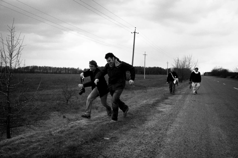 there is a black and white image of three men in motion